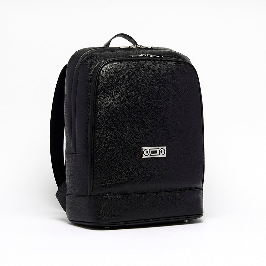 Three-quarter view of The Simona Monochrome Backpack in black pebbled leather, showcasing contemporary construction and understated elegance.