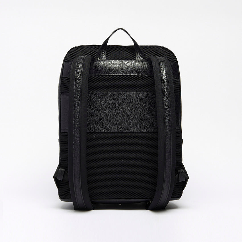 Back view of The Simona Monochrome Backpack in black pebbled leather with adjustable shoulder straps and clean architectural construction.